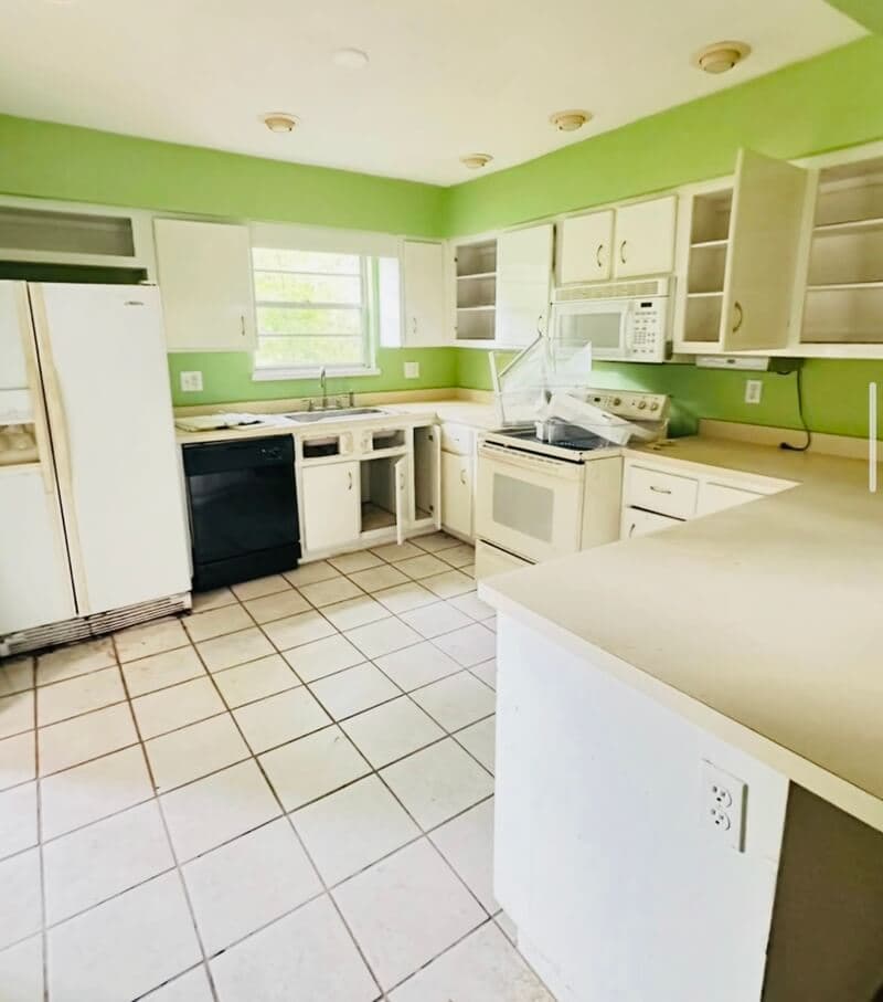 Kitchen before remodeling showing dated cabinets and worn fixtures in Gainesville, FL