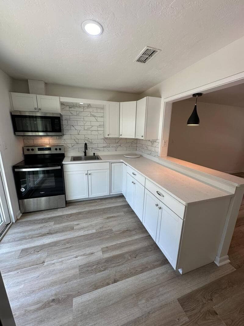 Professional kitchen renovation with custom cabinets and modern appliances completed by GMZ Remodeling in Gainesville, Florida