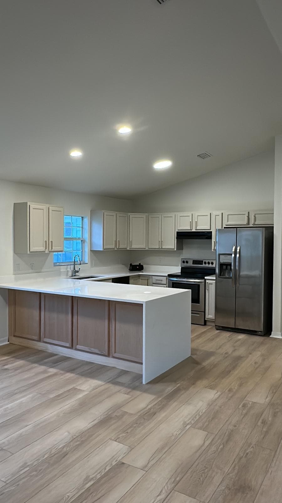 Professional kitchen remodel with custom cabinets and modern appliances completed by GMZ Home Builders in Gainesville, Florida